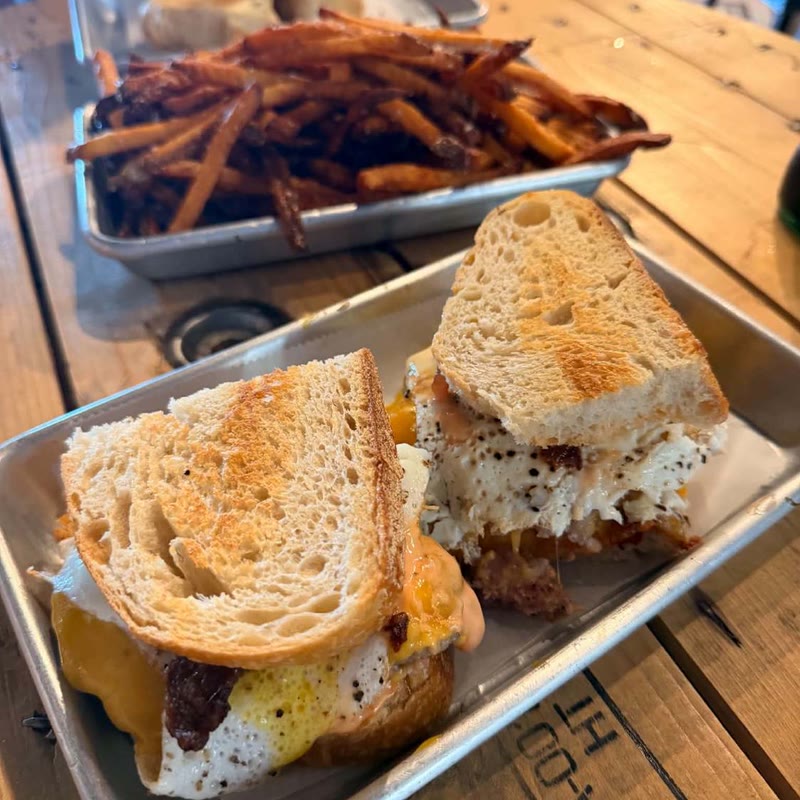 A breakfast sandwich with hand-cut fries.