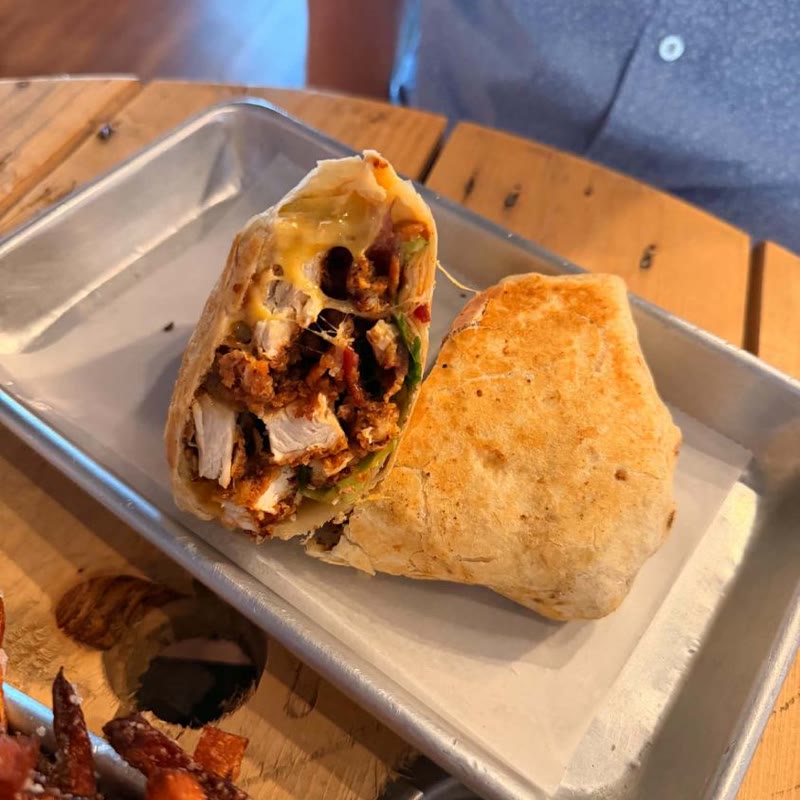 A fried chicken wrap with hand-cut fries.